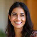 Photo of Aisha Saeed, a woman with a warm smile.