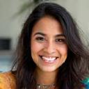 Photo of Fatima Ali, a young woman with artistic accessories, smiling.