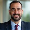 Photo of Khaled Mansour, a man in business attire, looking approachable.