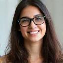 Photo of Sarah Hassan, a young woman smiling with glasses.